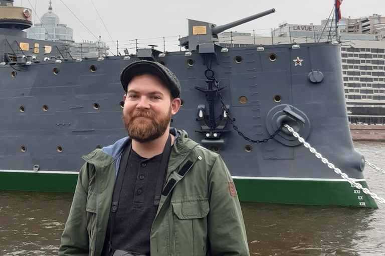 Nicholas Ingersoll poses in front of a ship during his FLAS award year in Russia.